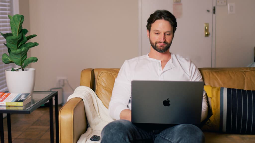 Sam coding at his couch